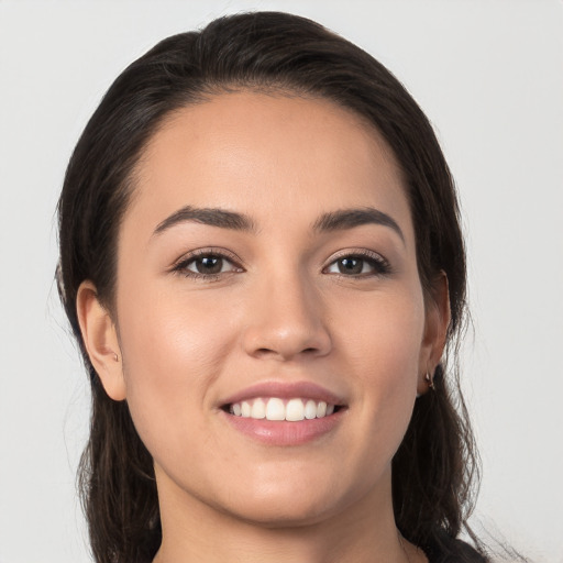 Joyful white young-adult female with long  brown hair and brown eyes