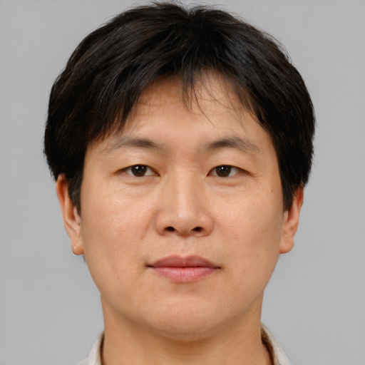 Neutral asian adult male with short  brown hair and brown eyes