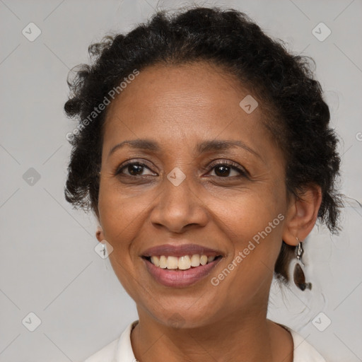 Joyful black adult female with medium  brown hair and brown eyes