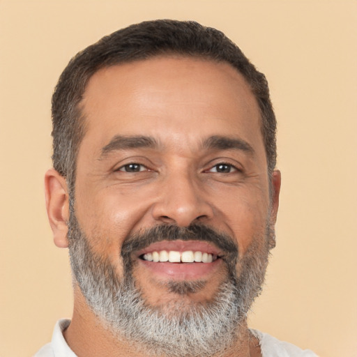 Joyful latino adult male with short  black hair and brown eyes