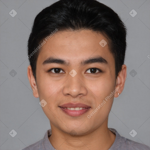 Joyful asian young-adult male with short  brown hair and brown eyes