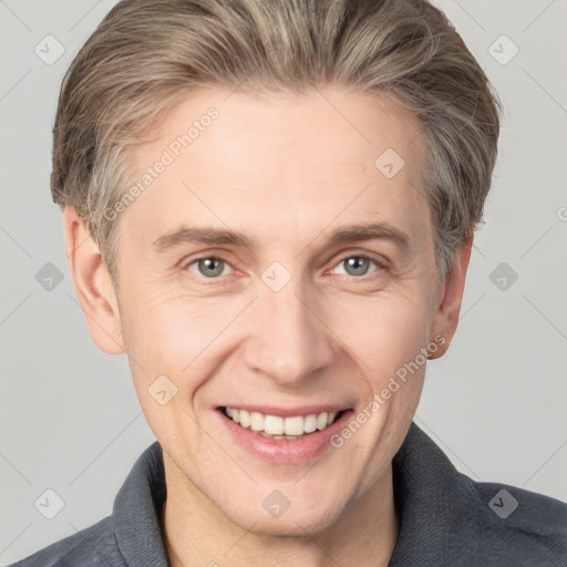 Joyful white adult male with short  brown hair and grey eyes