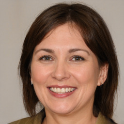 Joyful white adult female with medium  brown hair and brown eyes