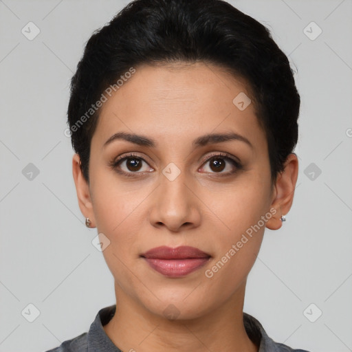 Joyful latino young-adult female with short  black hair and brown eyes