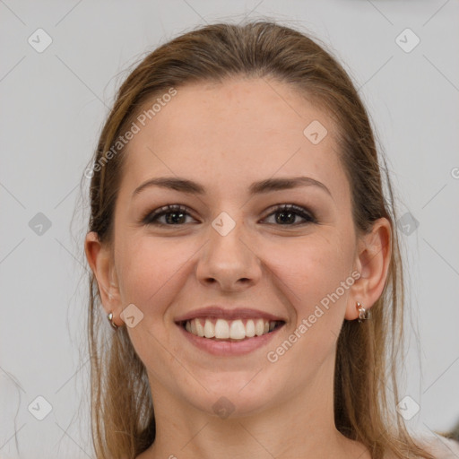 Joyful white young-adult female with long  brown hair and grey eyes