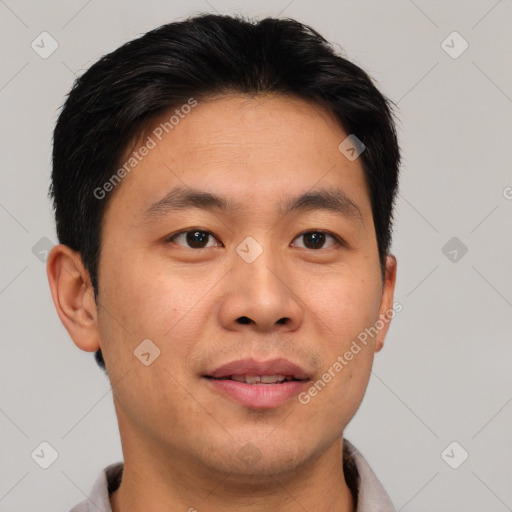 Joyful asian young-adult male with short  brown hair and brown eyes