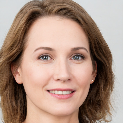 Joyful white young-adult female with long  brown hair and grey eyes