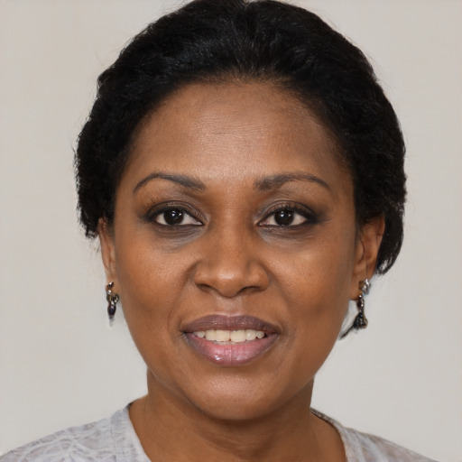 Joyful black adult female with short  brown hair and brown eyes