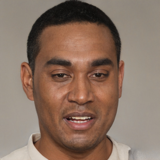 Joyful black young-adult male with short  black hair and brown eyes
