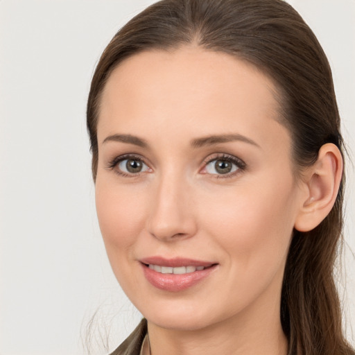 Joyful white young-adult female with long  brown hair and brown eyes