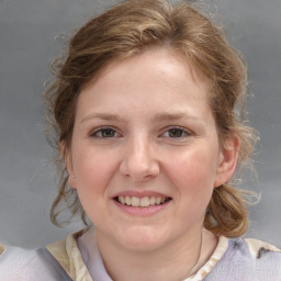 Joyful white young-adult female with medium  brown hair and blue eyes