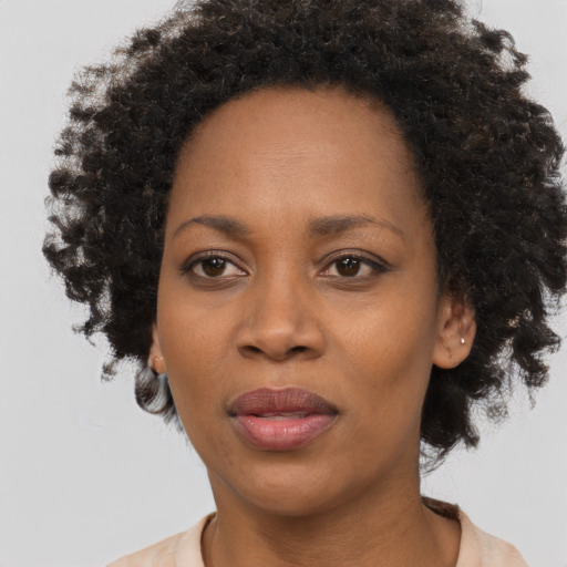 Joyful black adult female with medium  black hair and brown eyes