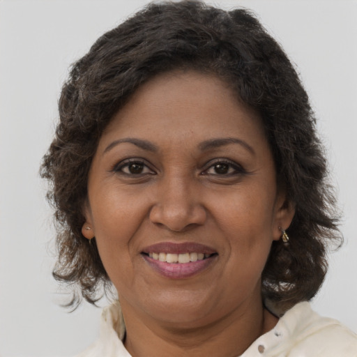 Joyful black adult female with medium  brown hair and brown eyes