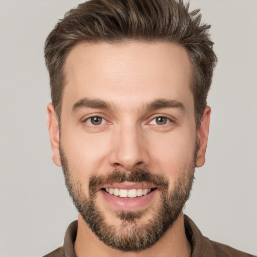 Joyful white young-adult male with short  brown hair and brown eyes