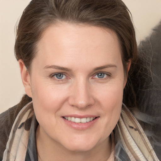 Joyful white young-adult female with long  brown hair and grey eyes