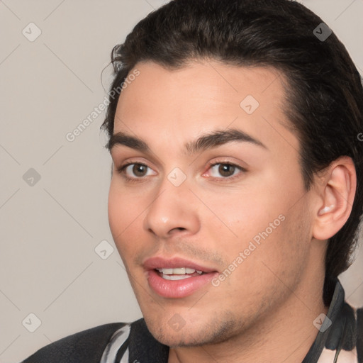 Joyful white young-adult male with short  black hair and brown eyes