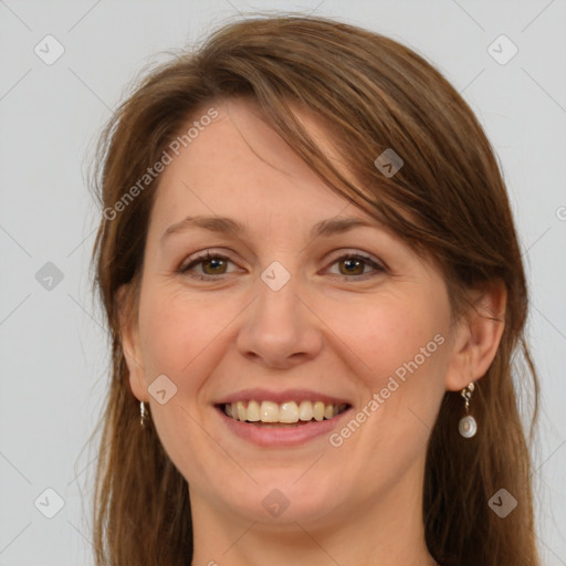 Joyful white adult female with long  brown hair and grey eyes