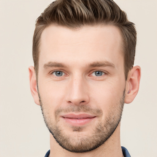 Joyful white young-adult male with short  brown hair and grey eyes