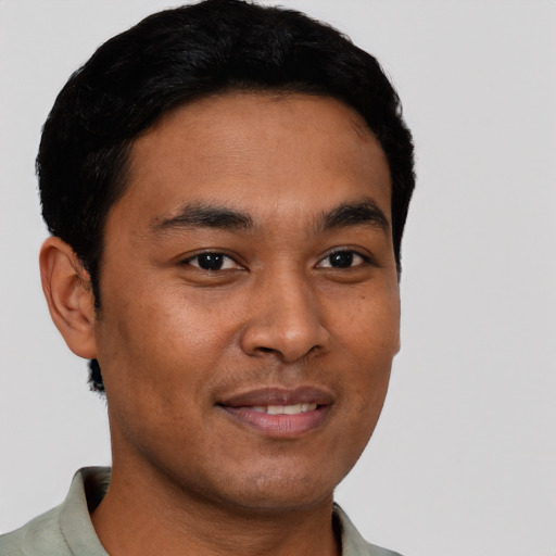 Joyful latino young-adult male with short  brown hair and brown eyes