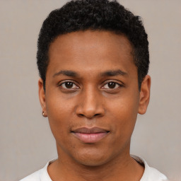 Joyful black young-adult male with short  black hair and brown eyes