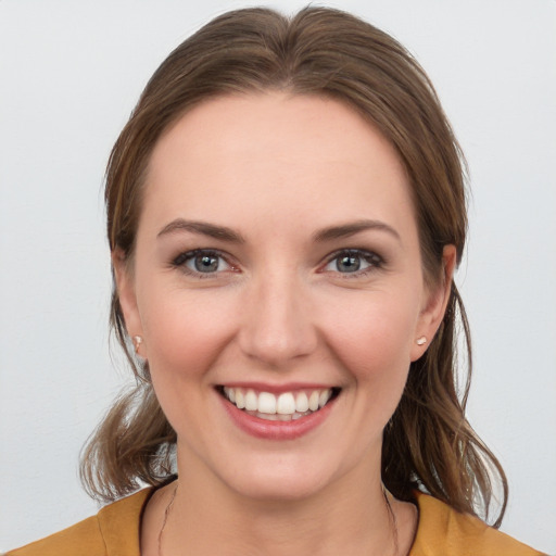 Joyful white young-adult female with medium  brown hair and brown eyes