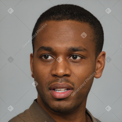 Joyful black young-adult male with short  brown hair and brown eyes