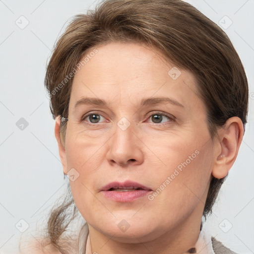 Joyful white adult female with medium  brown hair and grey eyes