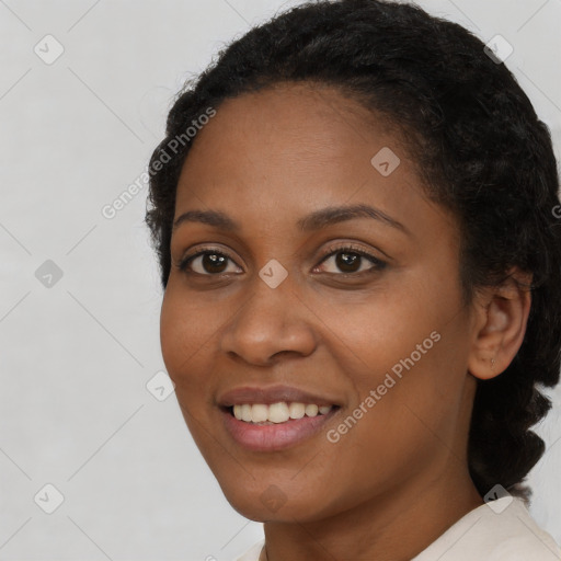 Joyful black young-adult female with short  black hair and brown eyes