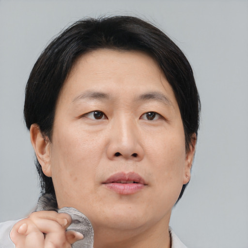 Neutral asian adult female with short  brown hair and brown eyes