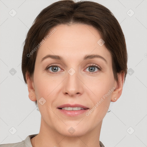 Joyful white adult female with short  brown hair and grey eyes