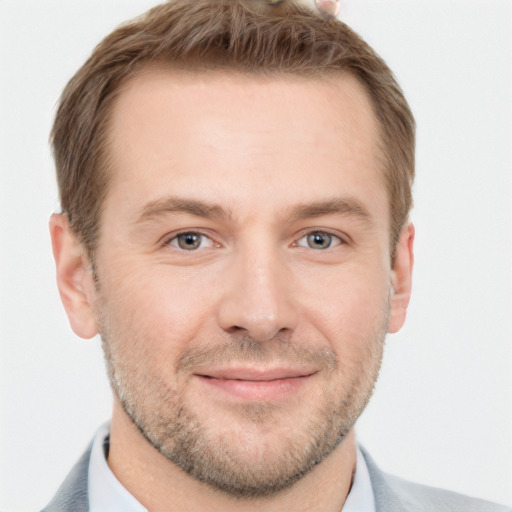 Joyful white adult male with short  brown hair and grey eyes