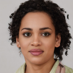 Joyful black young-adult female with long  brown hair and brown eyes