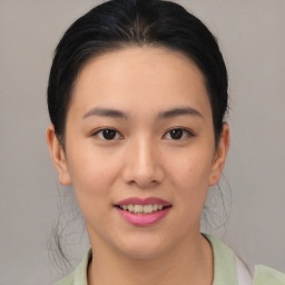 Joyful asian young-adult female with medium  brown hair and brown eyes