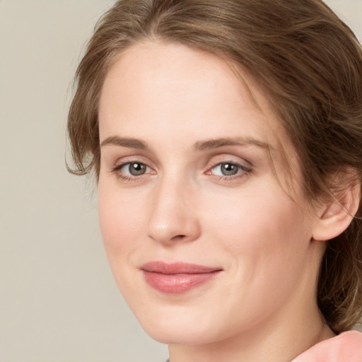 Joyful white young-adult female with medium  brown hair and green eyes