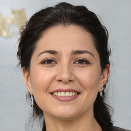 Joyful white adult female with medium  brown hair and brown eyes