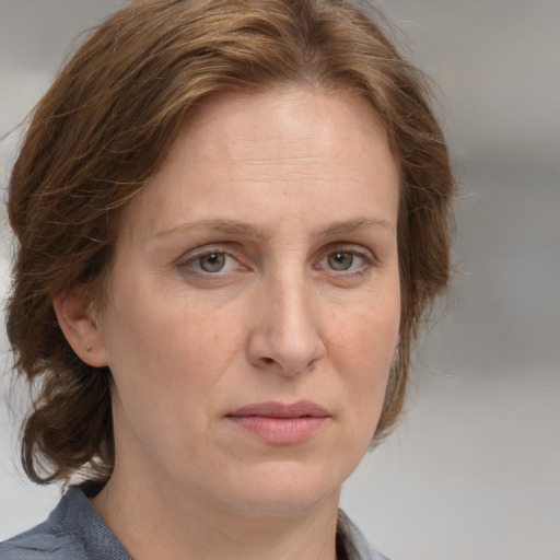 Joyful white adult female with medium  brown hair and blue eyes