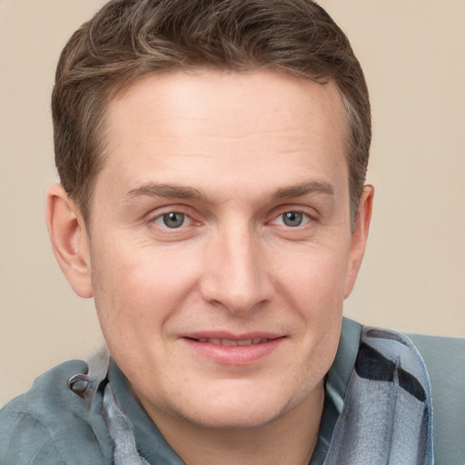 Joyful white adult male with short  brown hair and grey eyes