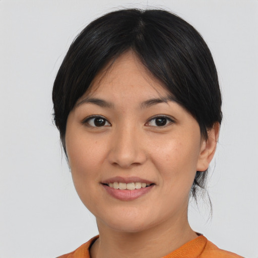 Joyful asian young-adult female with medium  brown hair and brown eyes
