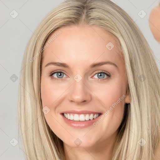 Joyful white young-adult female with long  brown hair and blue eyes