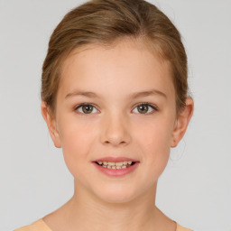 Joyful white child female with medium  brown hair and brown eyes