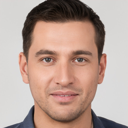 Joyful white young-adult male with short  brown hair and brown eyes