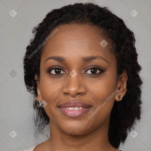 Joyful black young-adult female with long  brown hair and brown eyes