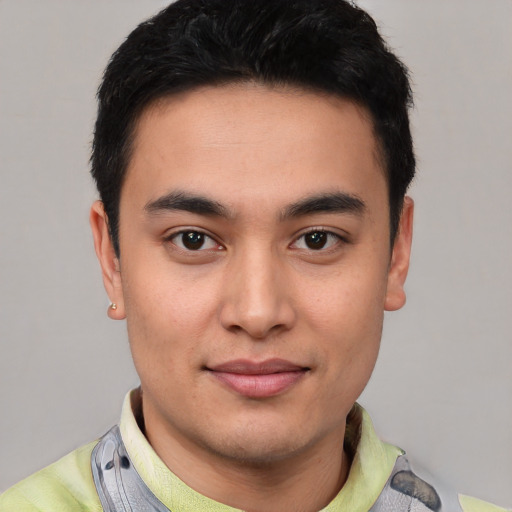 Joyful latino young-adult male with short  black hair and brown eyes