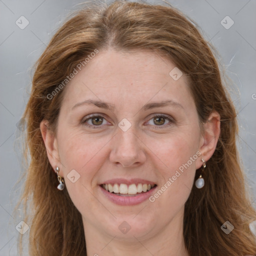 Joyful white adult female with long  brown hair and grey eyes