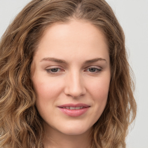 Joyful white young-adult female with long  brown hair and green eyes