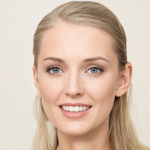 Joyful white young-adult female with long  brown hair and blue eyes