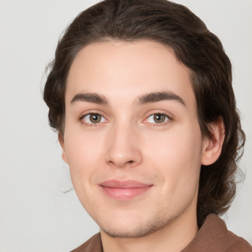 Joyful white young-adult male with medium  brown hair and brown eyes