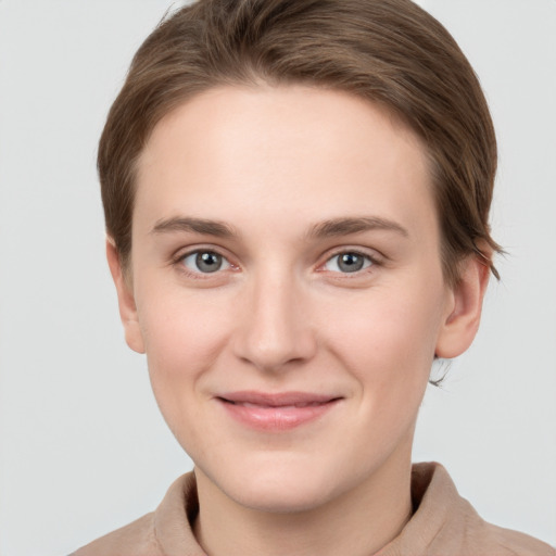 Joyful white young-adult female with short  brown hair and grey eyes