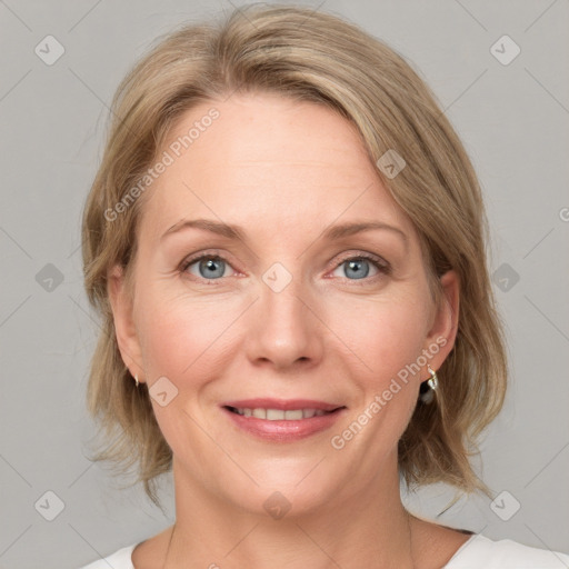 Joyful white adult female with medium  brown hair and blue eyes