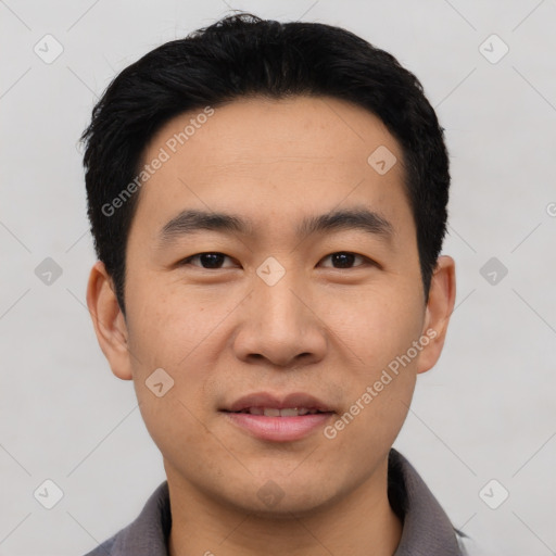 Joyful asian young-adult male with short  black hair and brown eyes